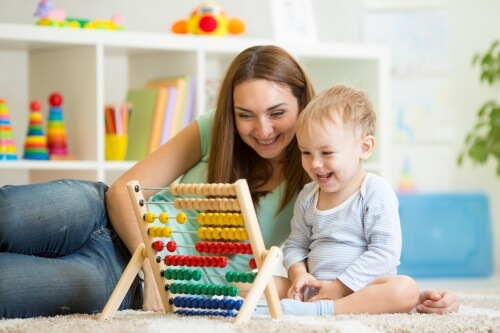 Homeschool Mom Playing With Child and Abacus